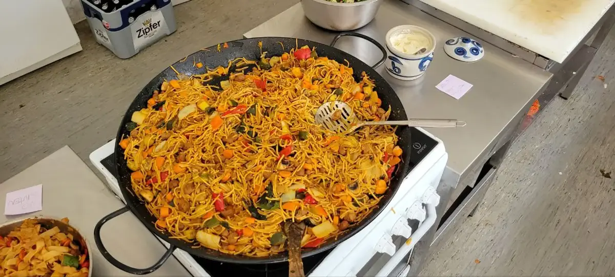 A giant pan of paella in the restaurant kitchen