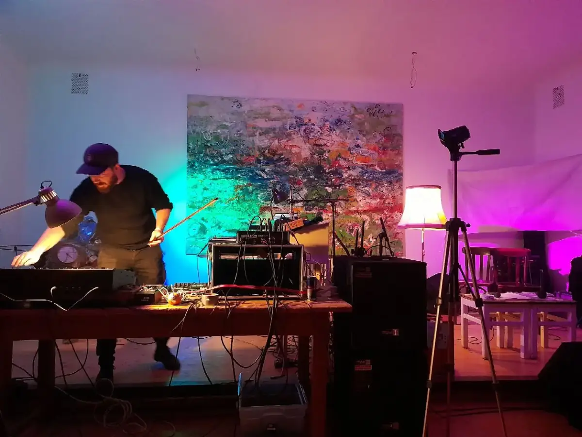 A musician performing in the hall under coloured light
